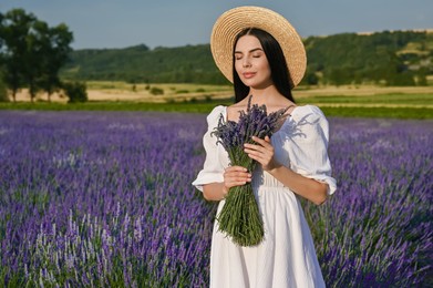 Photo of Beautiful young woman with bouquet in lavender field