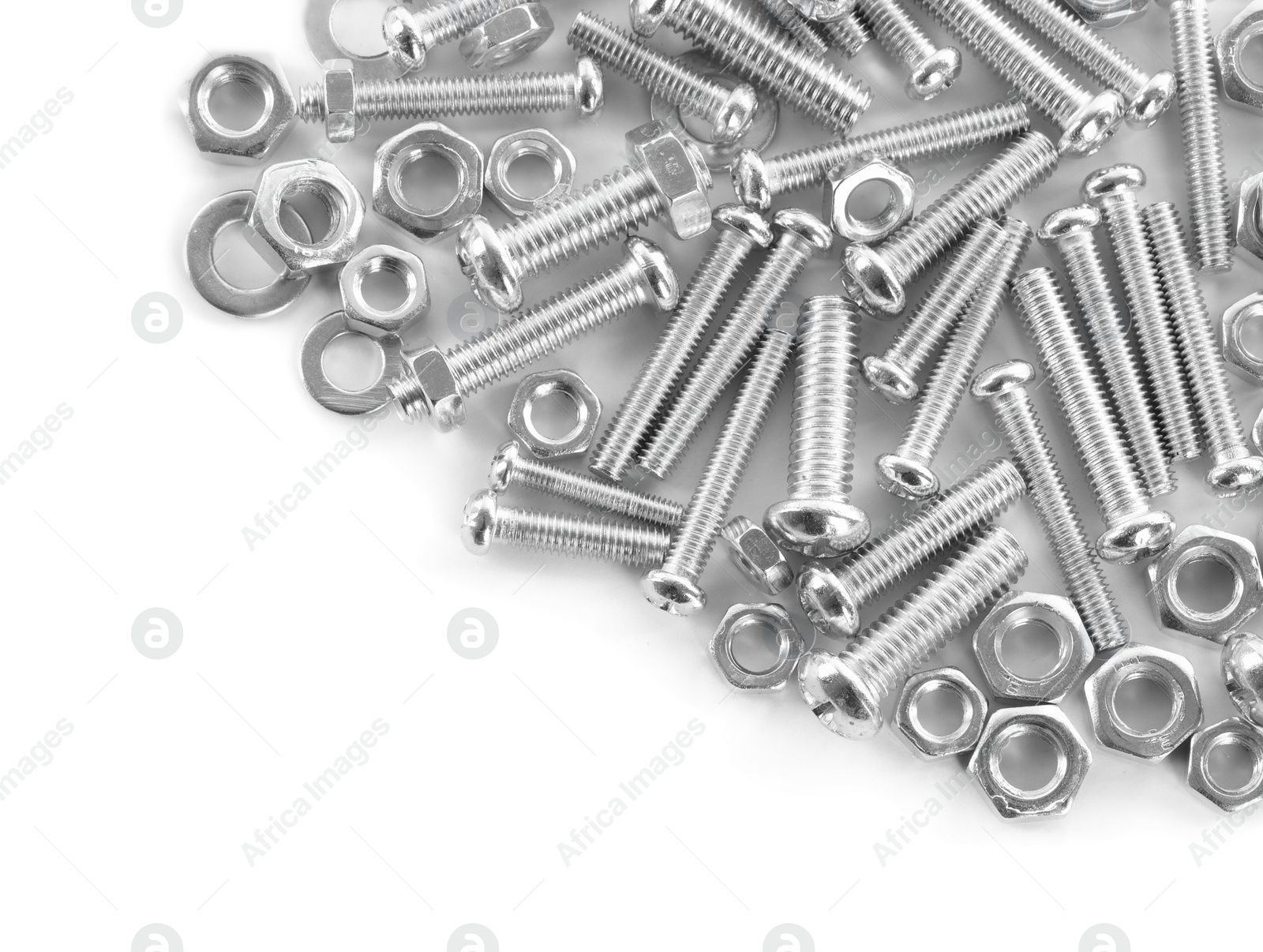 Photo of Many metal bolts and nuts on white background, top view