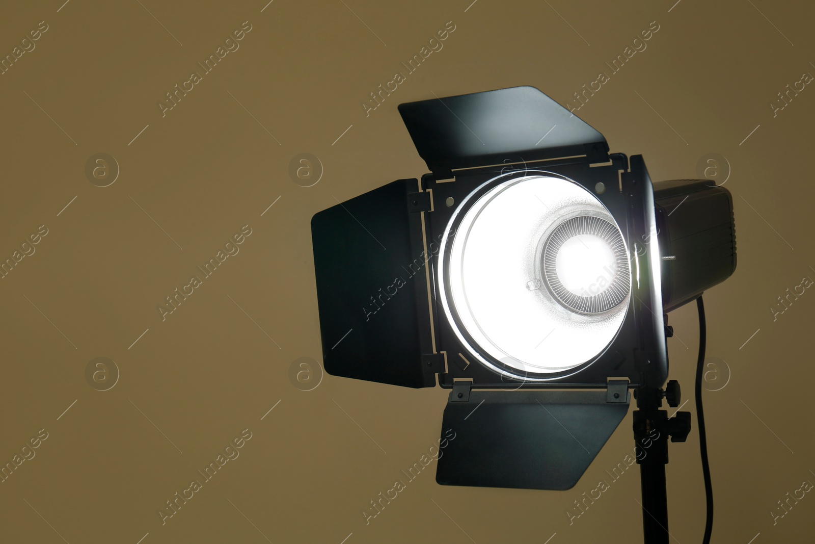 Photo of Modern spotlight against beige background, space for text