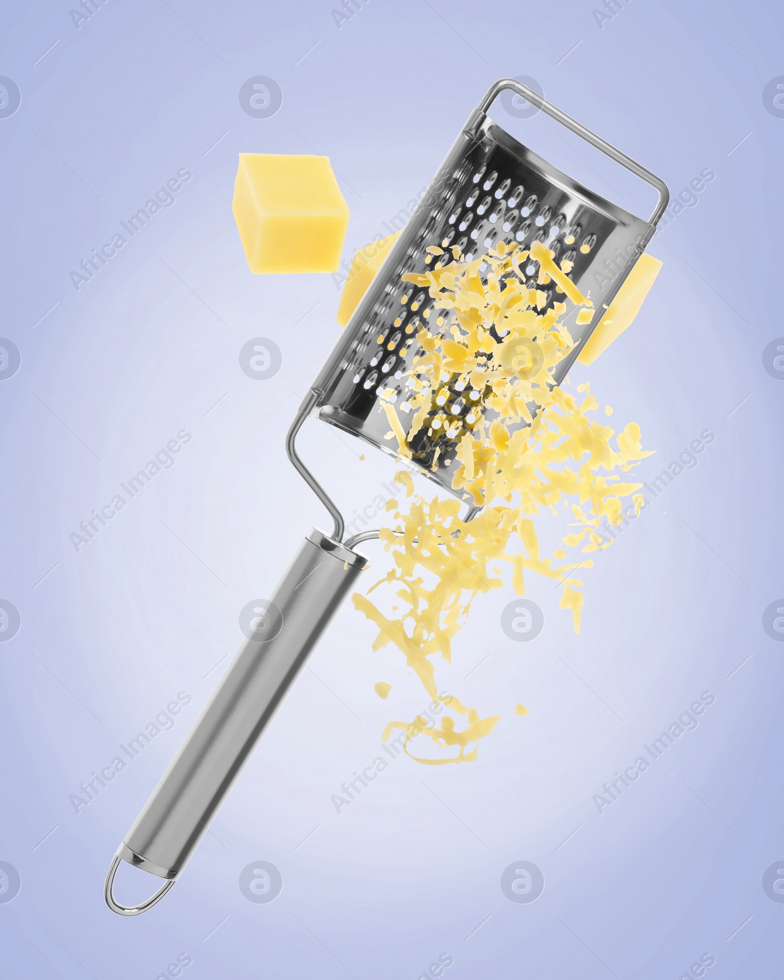 Image of Grating cheese with hand grater on blue background