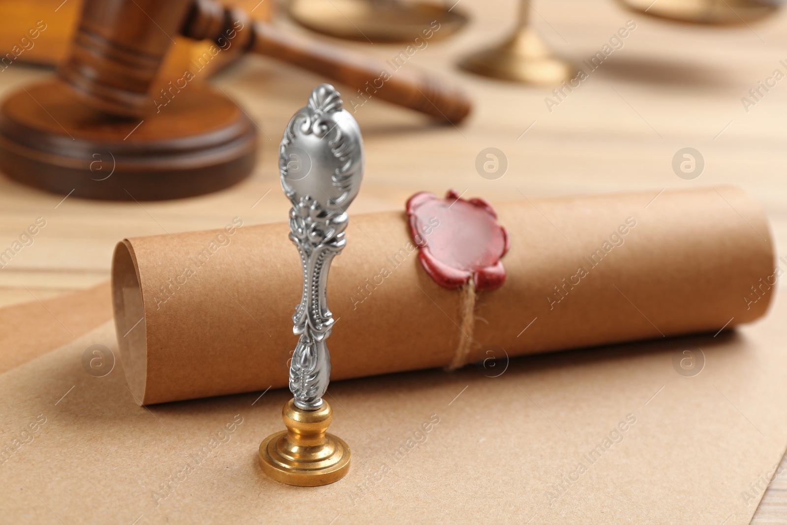 Photo of Notary's public pen and document with wax stamp on table, closeup