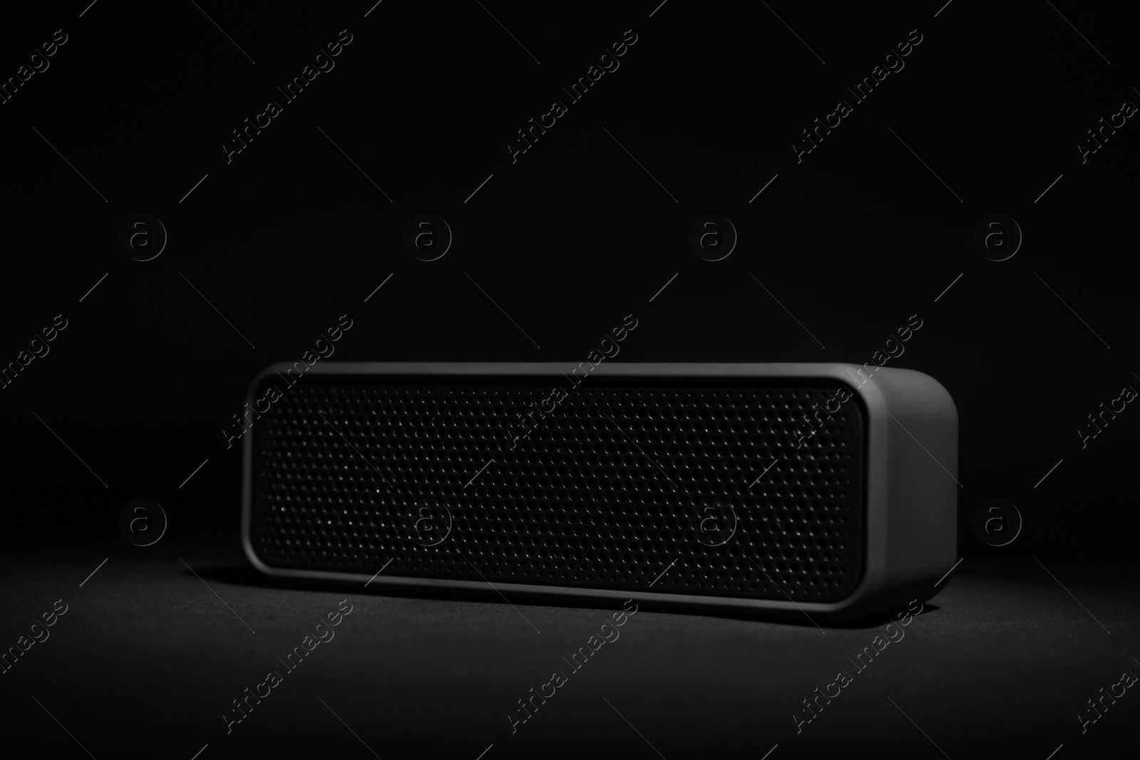 Photo of One portable bluetooth speaker on black background. Audio equipment