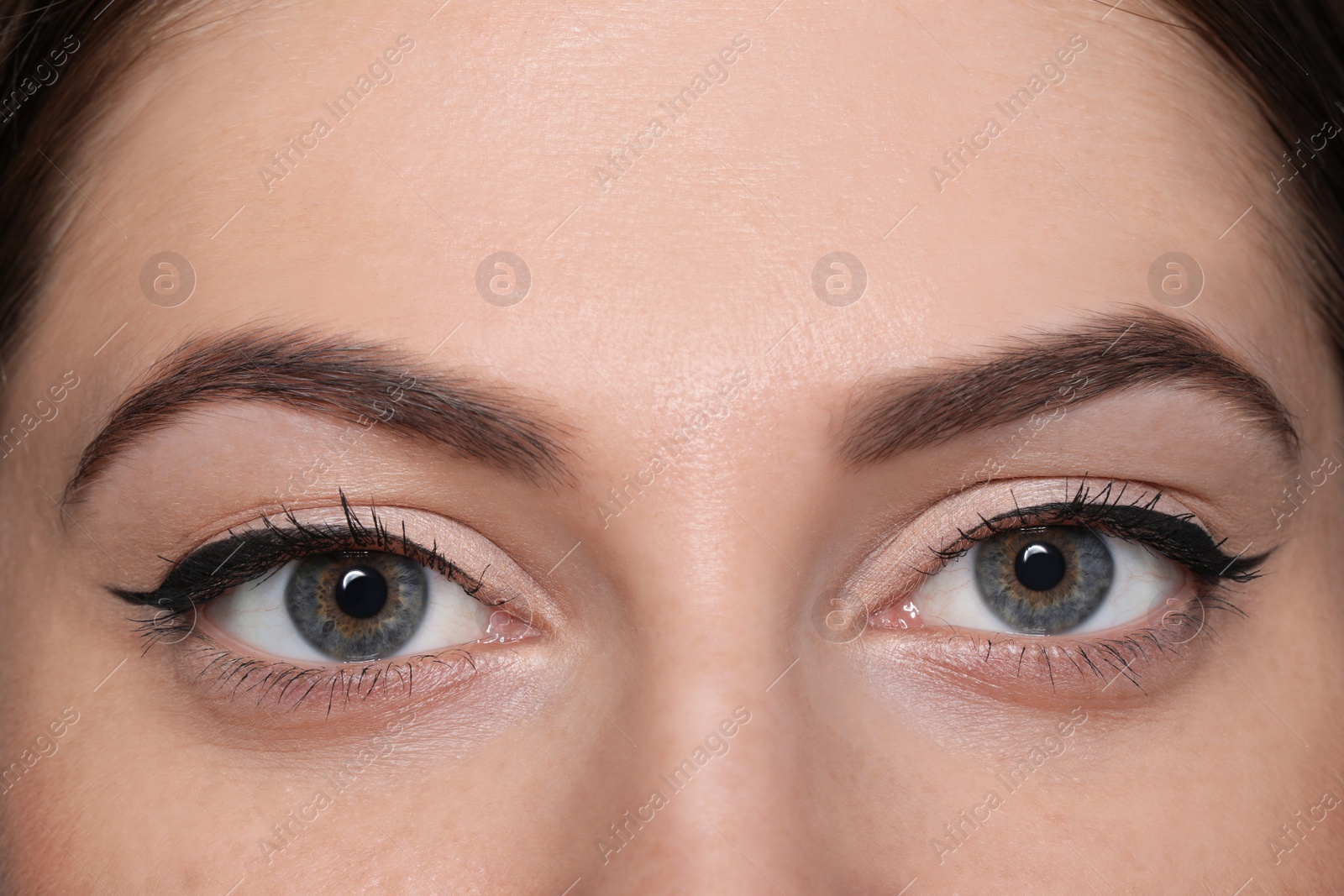 Photo of Beautiful woman with black eyeliner, closeup view