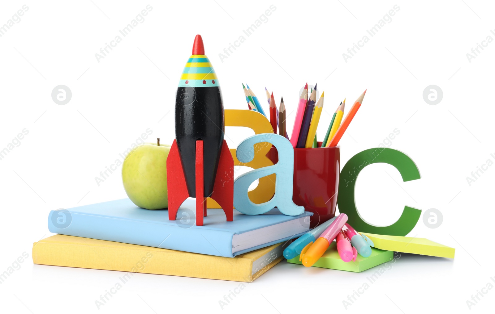 Photo of Bright toy rocket and school supplies on white background