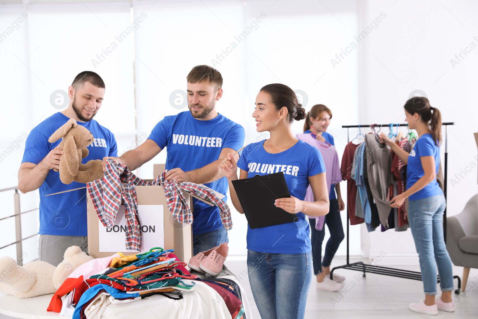 Photo of Team of young volunteers collecting donations indoors