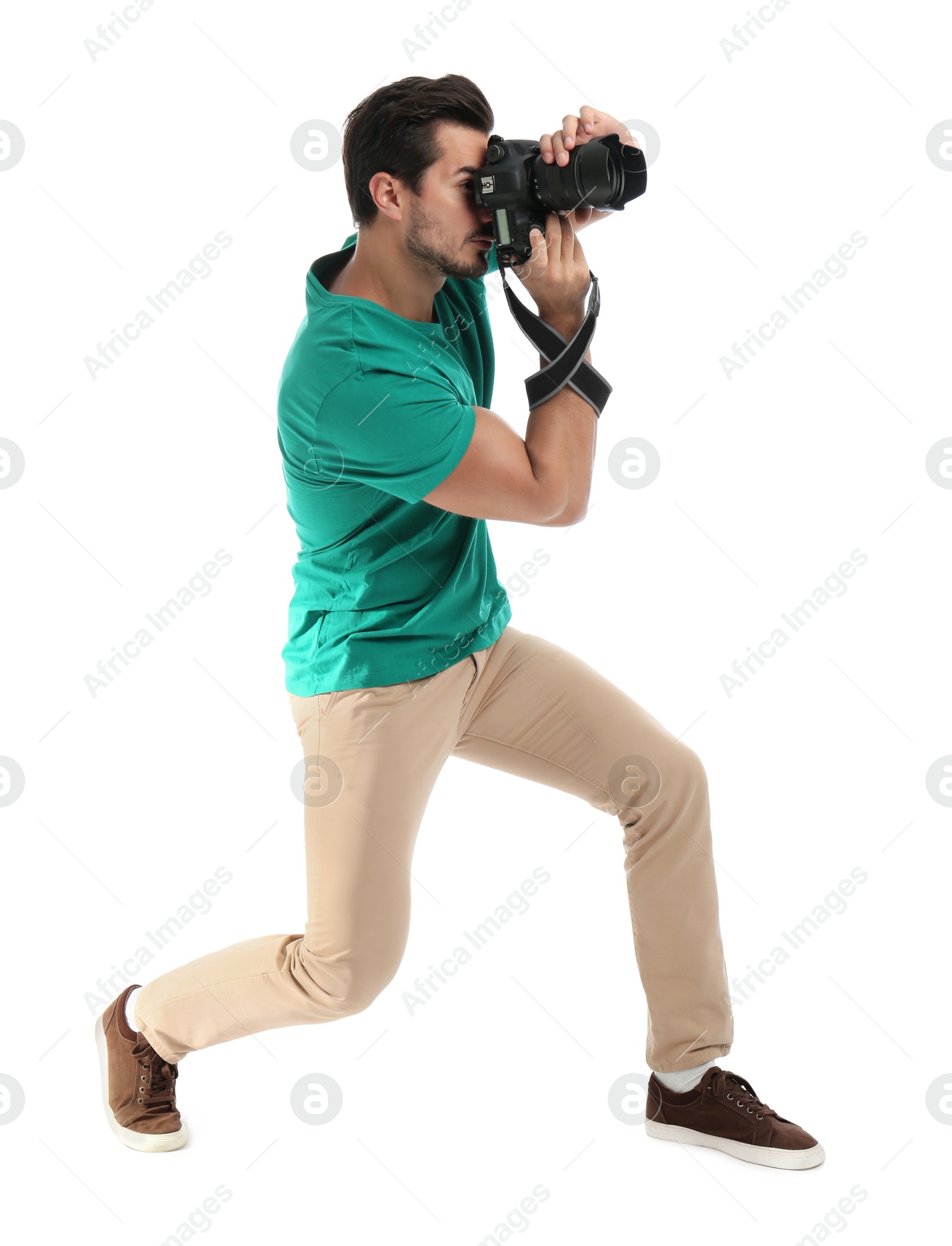 Photo of Young professional photographer taking picture on white background