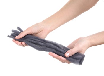 Woman holding grey felting wool on white background, closeup