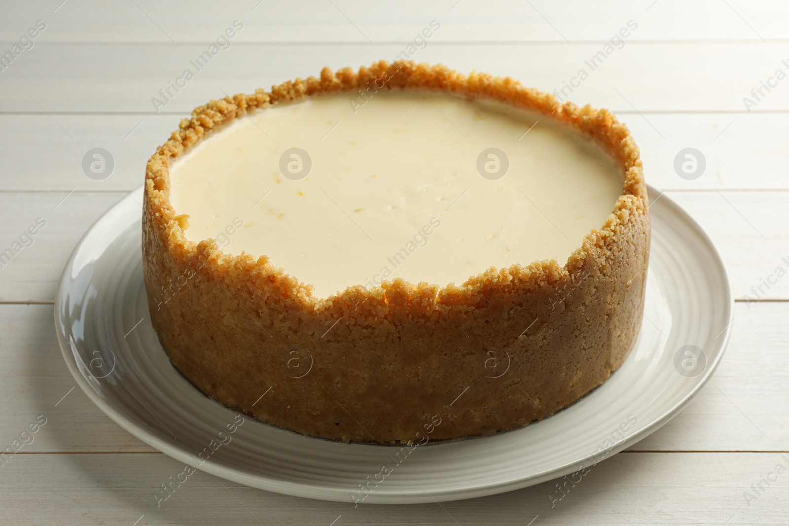 Photo of Tasty vegan tofu cheesecake on white wooden table