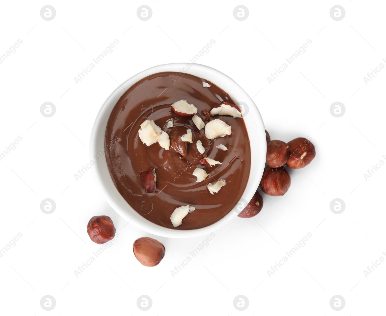 Photo of Dessert bowl with chocolate cream and hazelnuts isolated on white, top view