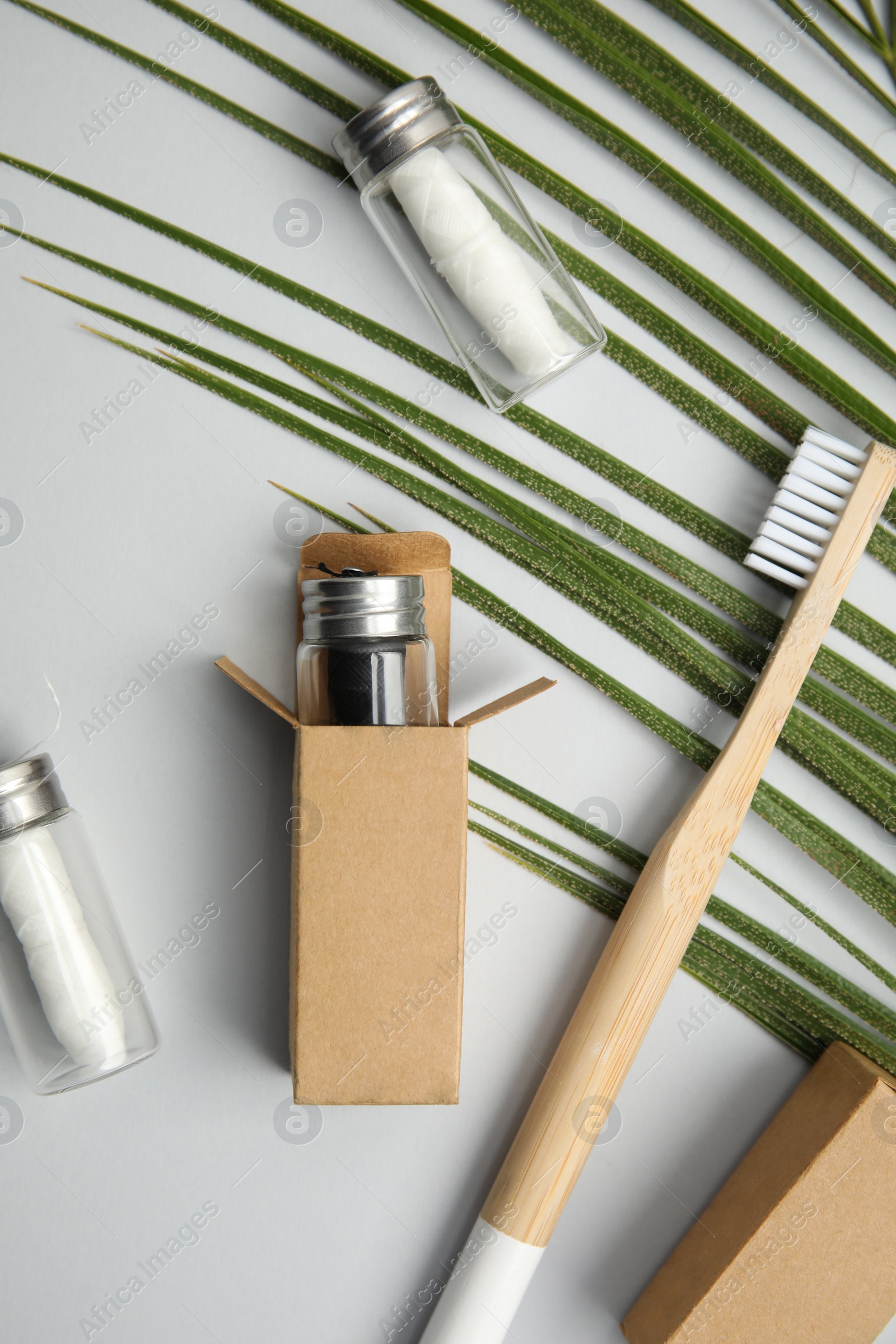 Photo of Flat lay composition with natural dental floss on light grey background