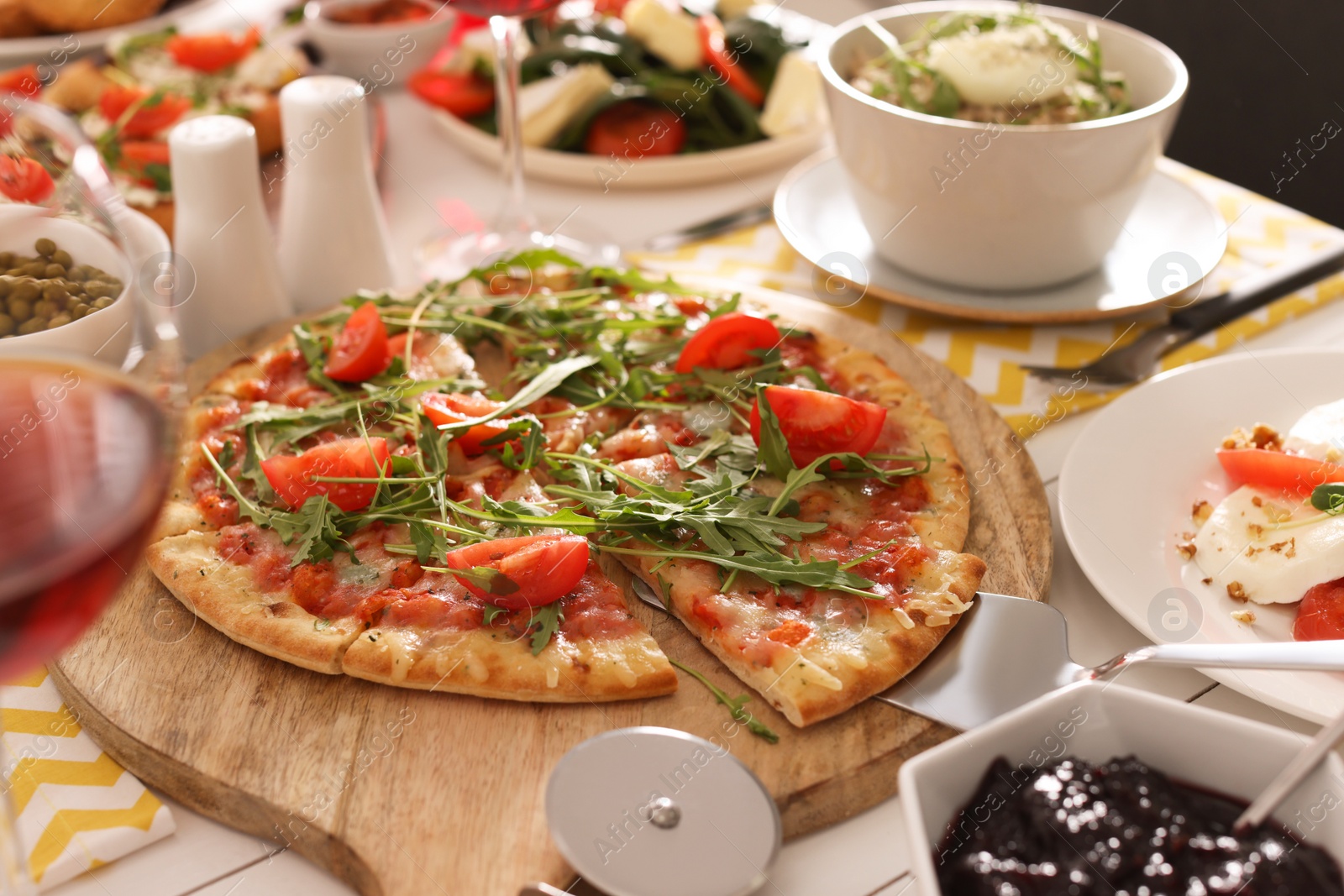 Photo of Pizza and many different dishes served on buffet table for brunch