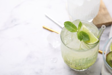 Photo of Glass of refreshing drink with lime and mint on white table, closeup. Space for text