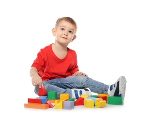 Little child playing with colorful building blocks on white background