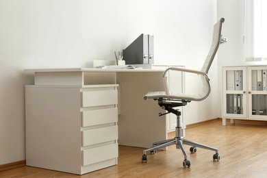 Stylish workplace interior with modern office chair and desk