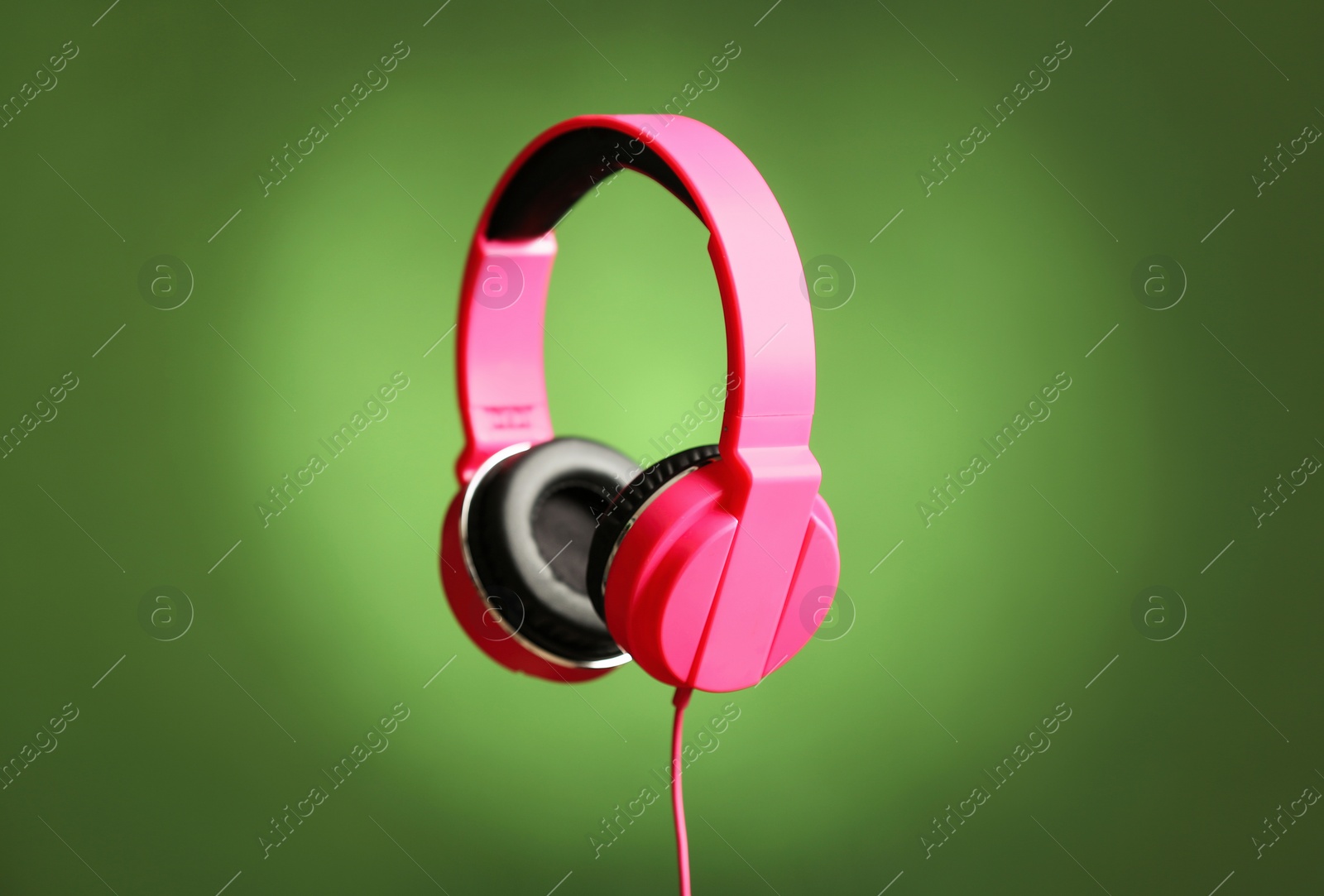 Photo of Stylish headphones with pads on color background