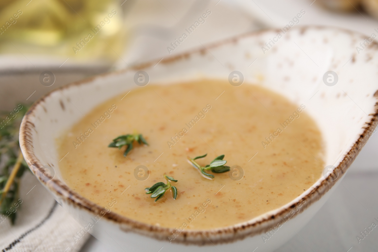 Photo of Delicious turkey gravy and thyme on table, closeup