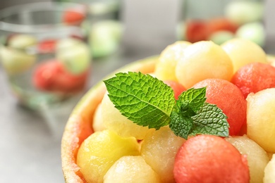 Photo of Melon and watermelon balls with mint served on table, closeup