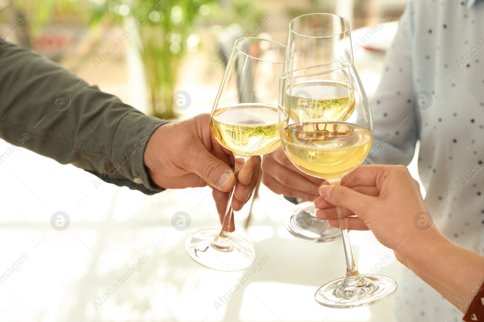 Photo of People with glasses of wine on blurred background, closeup