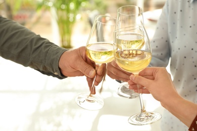 People with glasses of wine on blurred background, closeup