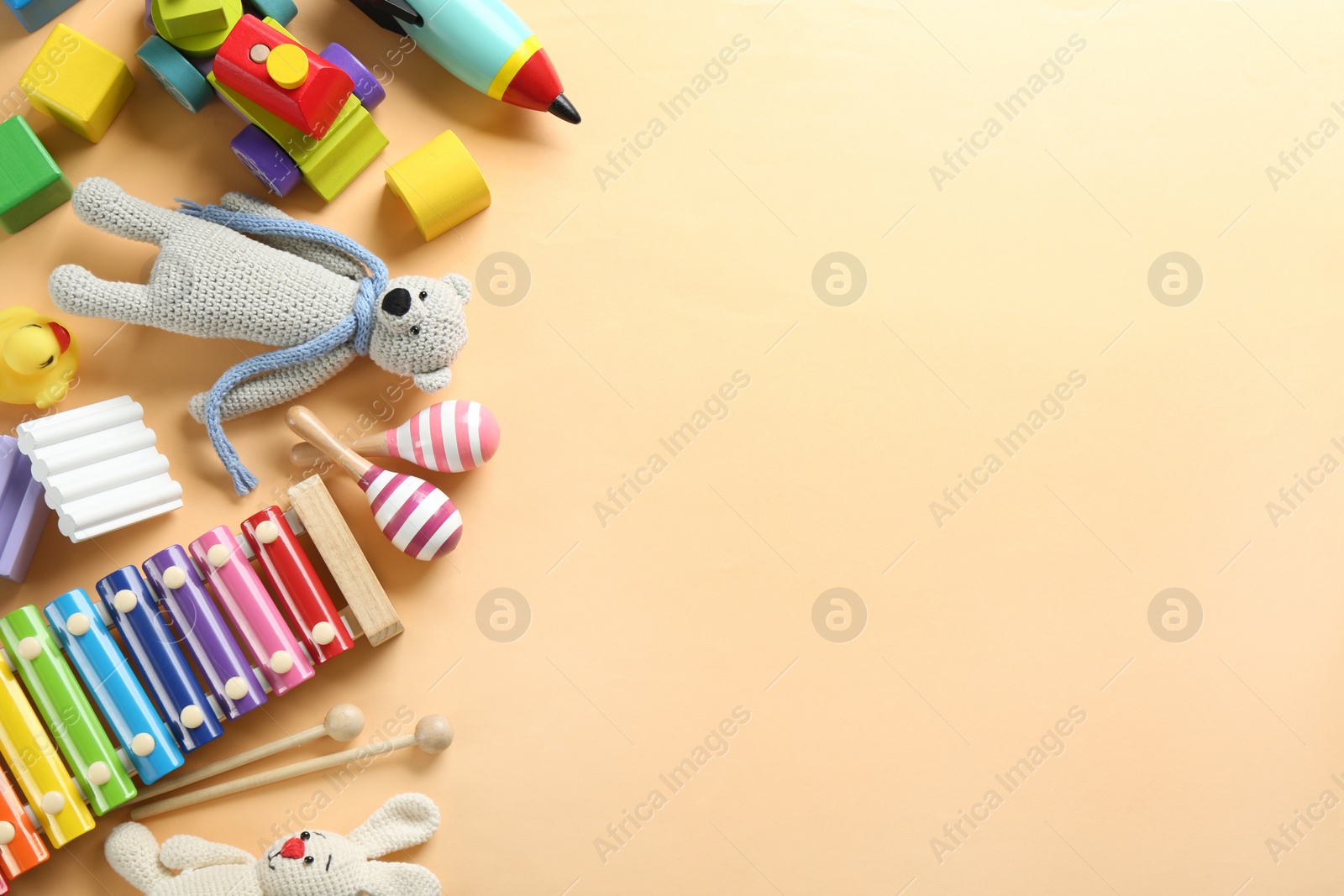Photo of Different toys on beige background, flat lay. Space for text