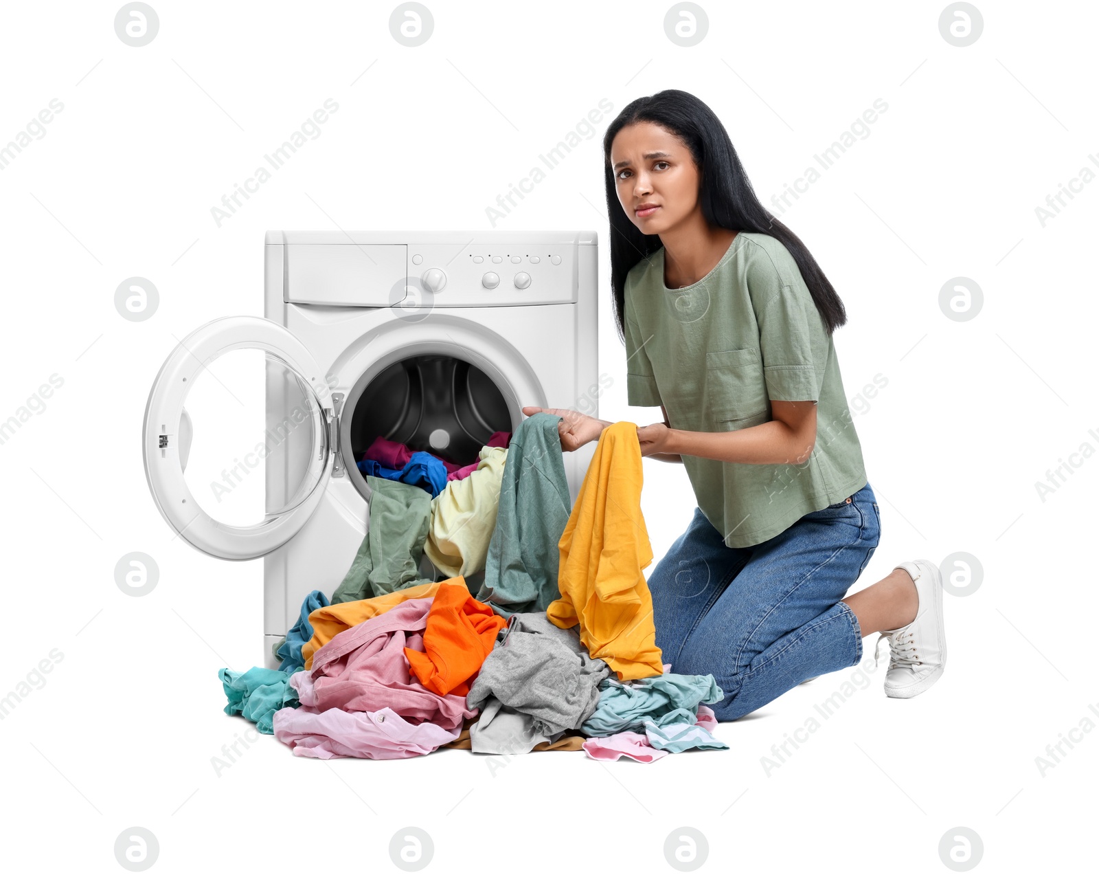 Photo of Unhappy woman with dirty clothes near washing machine on white background