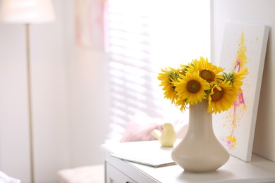 Photo of Beautiful bouquet of sunflowers in vase on white table indoors. Space for text