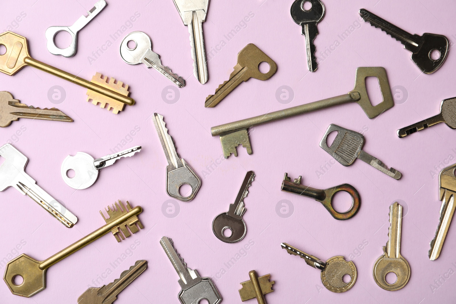 Photo of Steel keys on pink background, flat lay. Safety concept