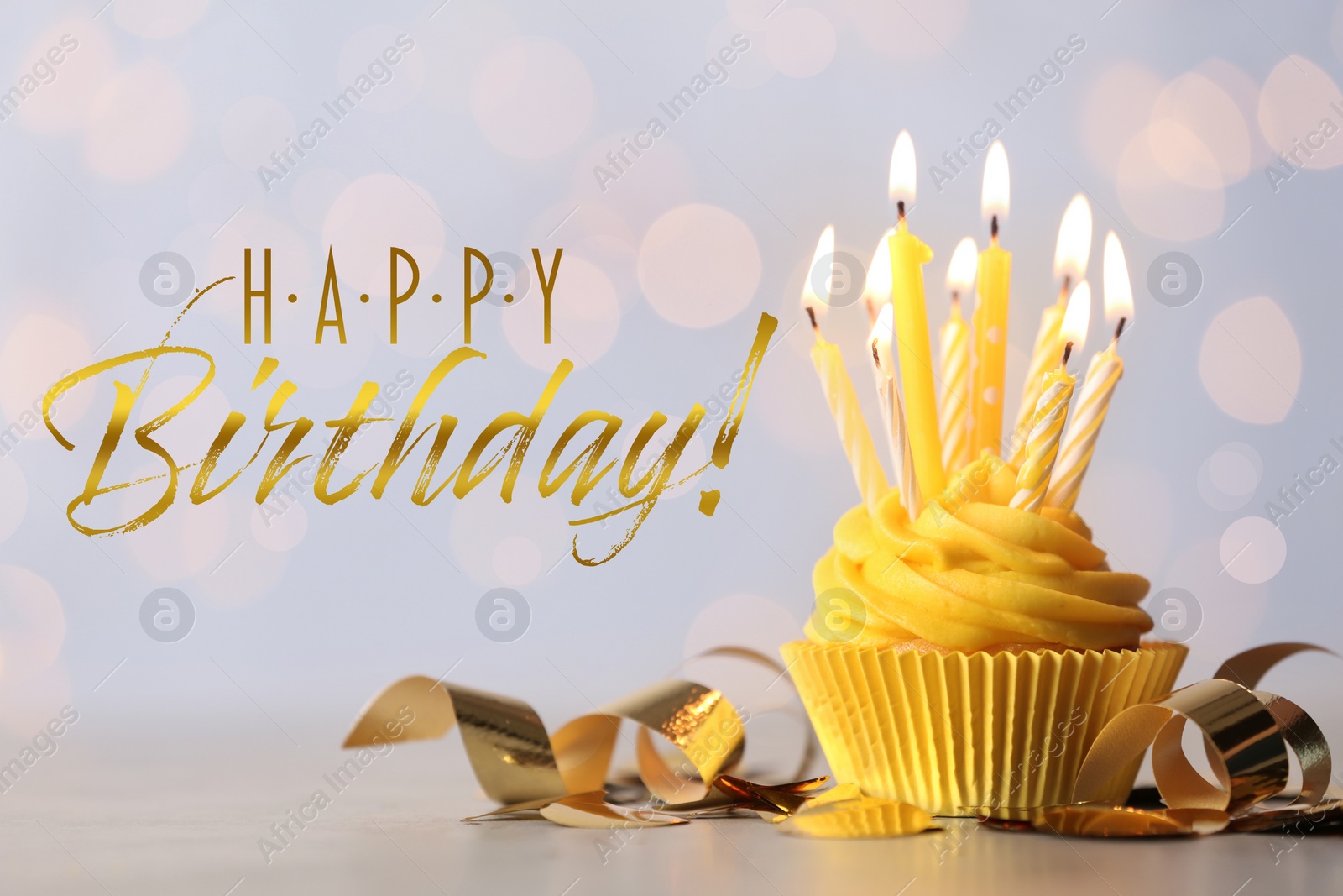 Image of Happy Birthday! Delicious cupcake with burning candles on table