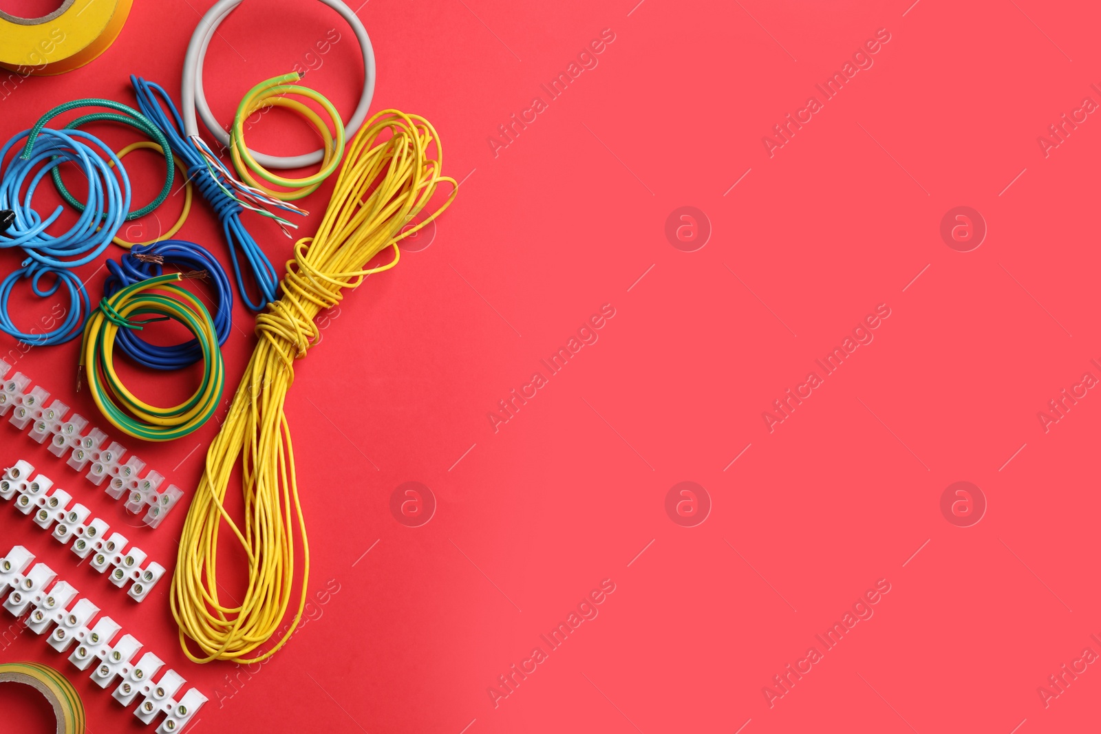 Photo of Flat lay composition with electrician's accessories on red background, space for text