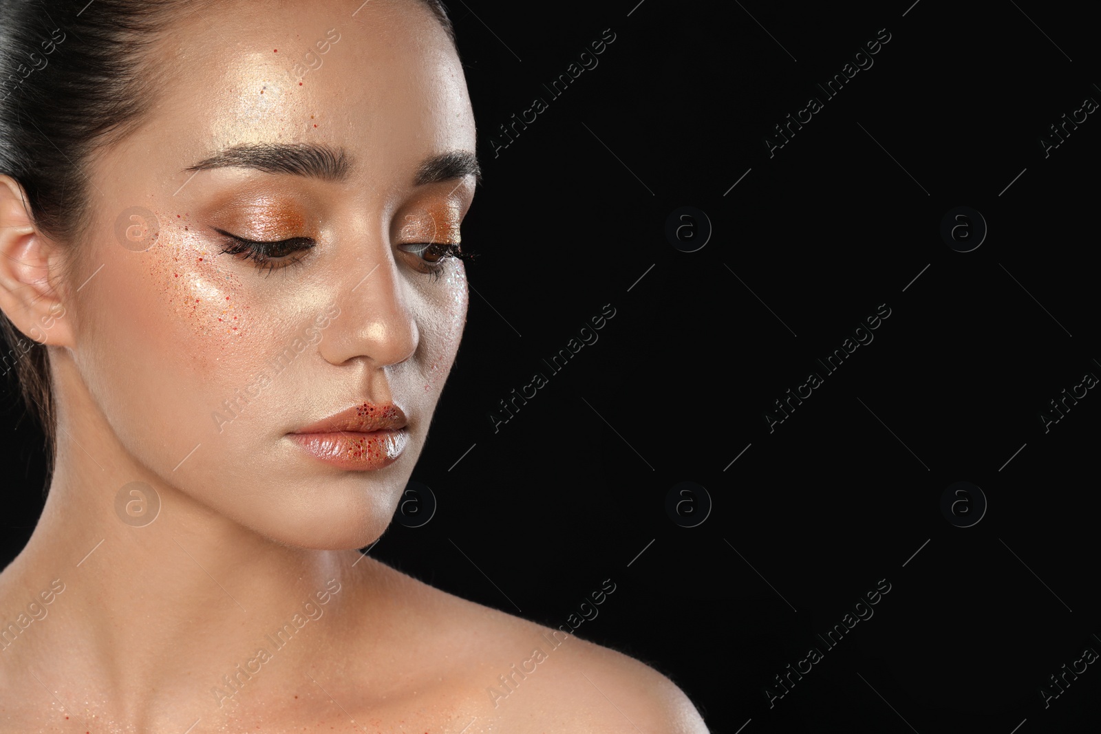 Photo of Beautiful young woman with glitter makeup on black background, space for text