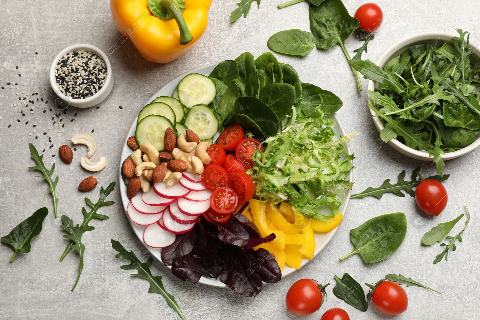 Photo of Balanced diet and vegetarian foods. Plate with different delicious products on grey table, flat lay