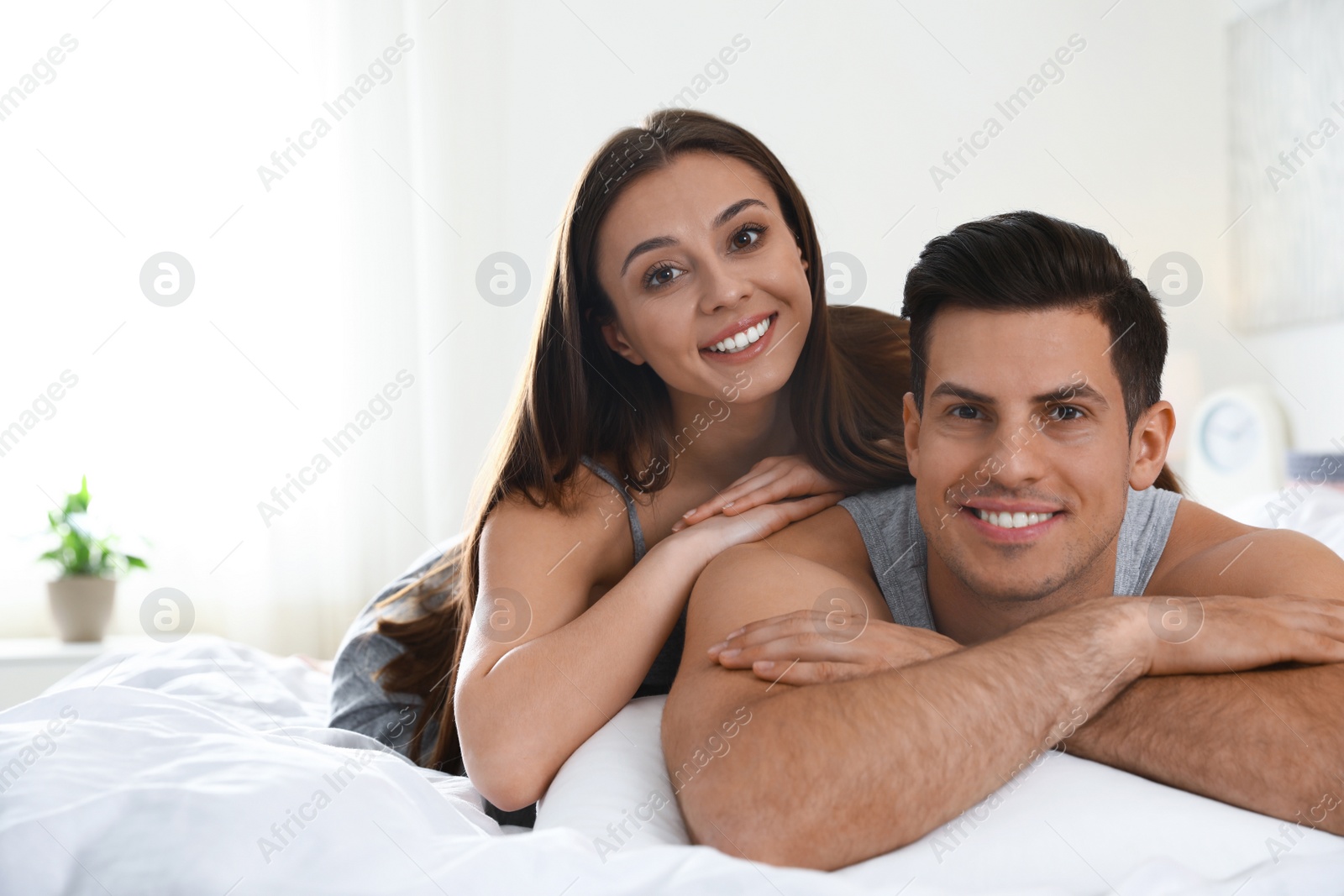 Photo of Portrait of lovely couple resting on large bed