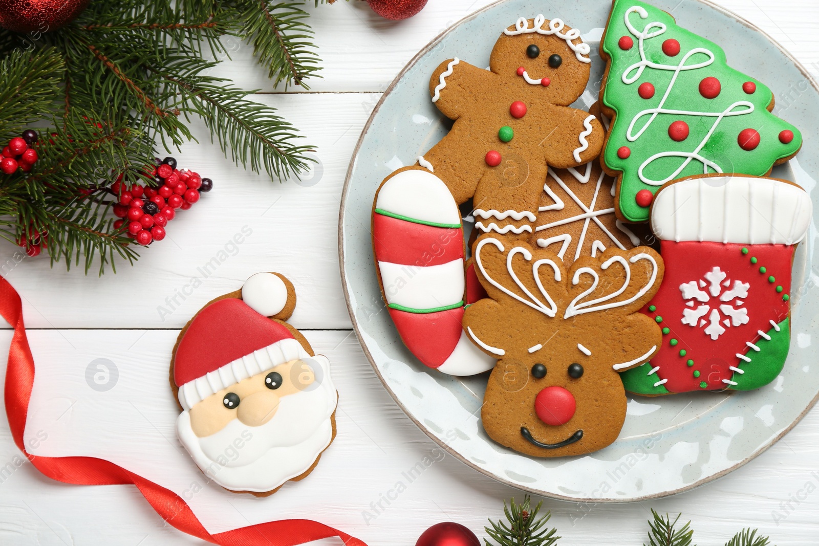Photo of Tasty homemade Christmas cookies and decor on white wooden table, flat lay