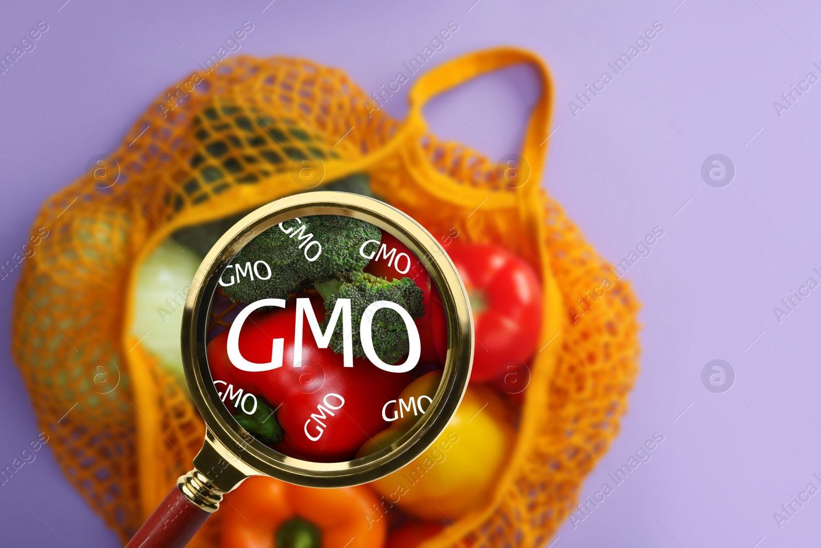 Image of View through magnifying glass on fresh vegetables, top view. GMO concept