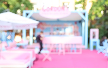 Photo of Blurred view of modern open air cafe on sunny day. Bokeh effect