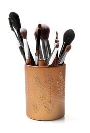 Holder with makeup brushes of professional artist on white background