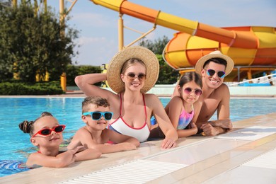 Photo of Happy family in swimming pool at water park