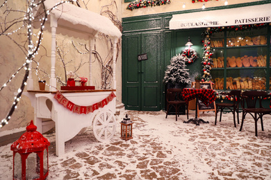 Stylish candy cart near outdoor cafe. Christmas holidays