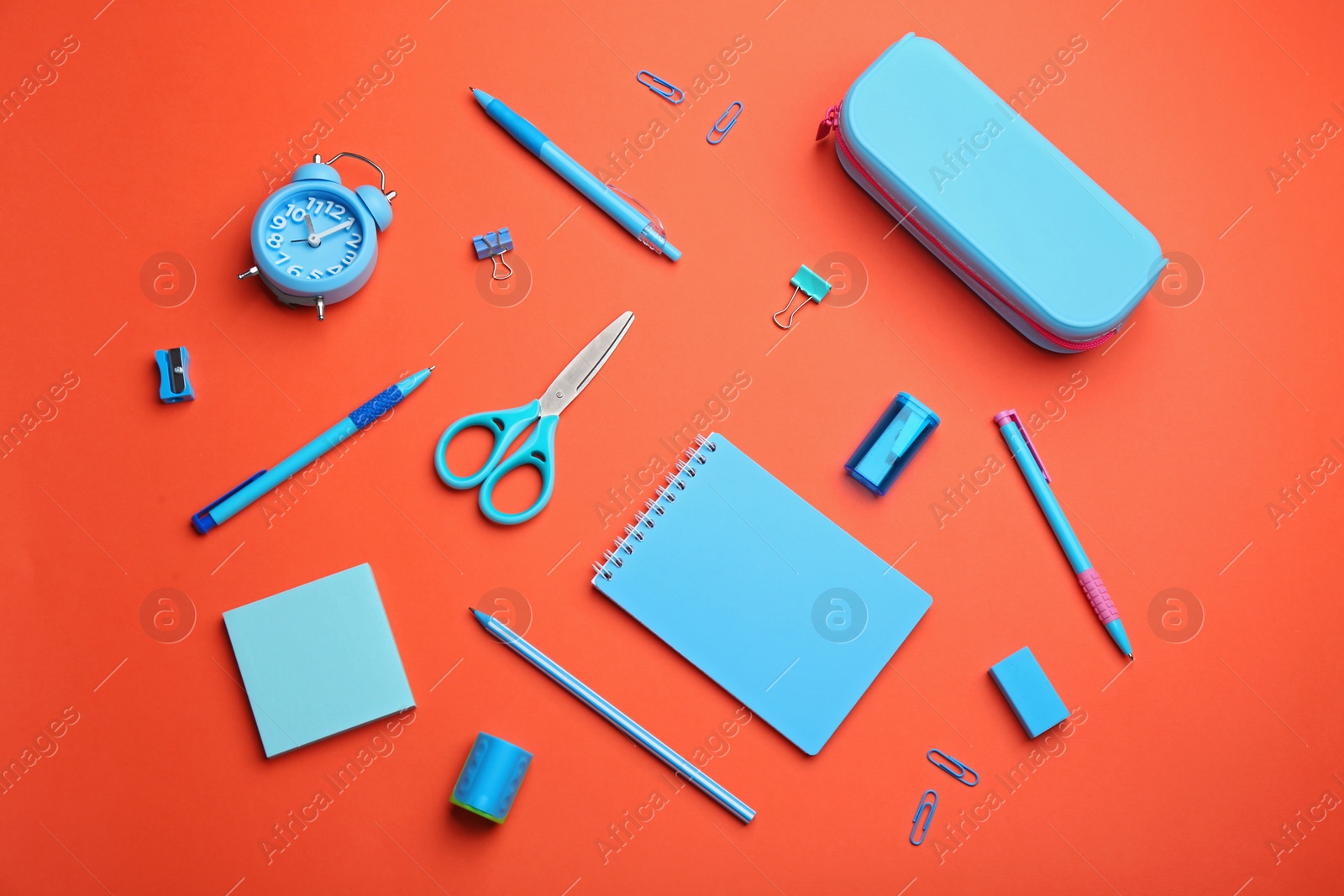 Photo of Different bright school stationery on coral background, flat lay