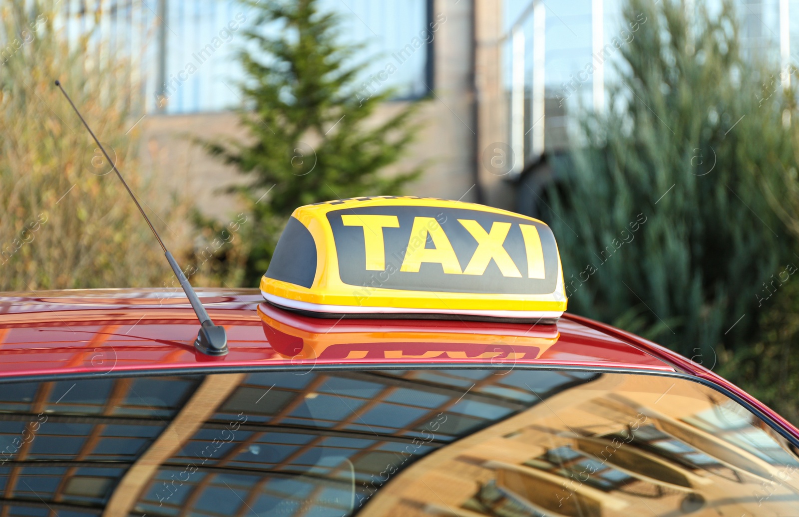 Photo of Roof light with word TAXI on car outdoors