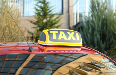 Photo of Roof light with word TAXI on car outdoors