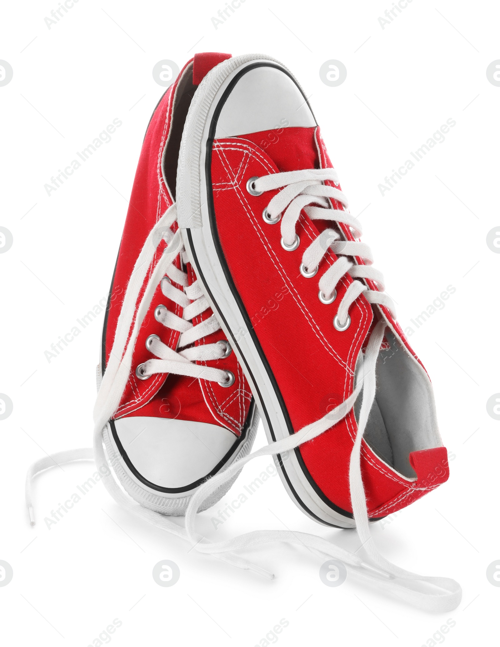 Photo of Stylish red canvas shoes with laces on white background
