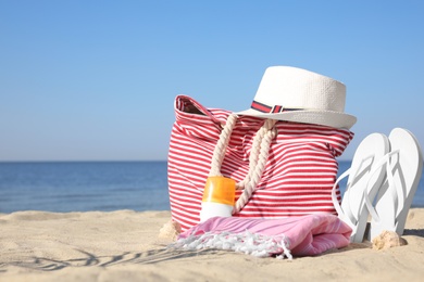 Stylish beach accessories on sandy sea shore