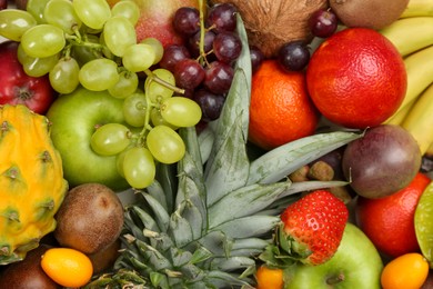 Photo of Assortment of fresh exotic fruits as background, top view