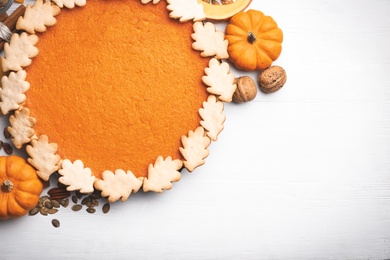 Photo of Delicious homemade pumpkin pie on white wooden table, flat lay. Space for text