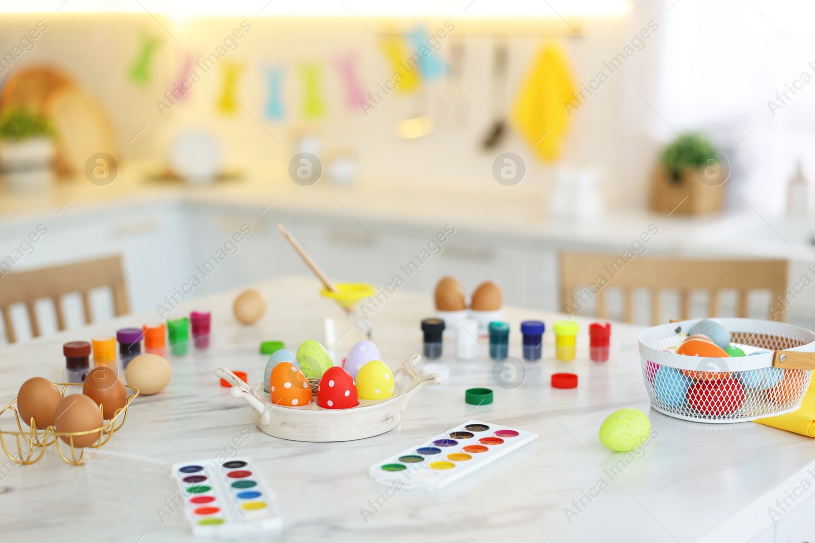 Photo of Happy Easter. Painted eggs and watercolor on white marble table indoors