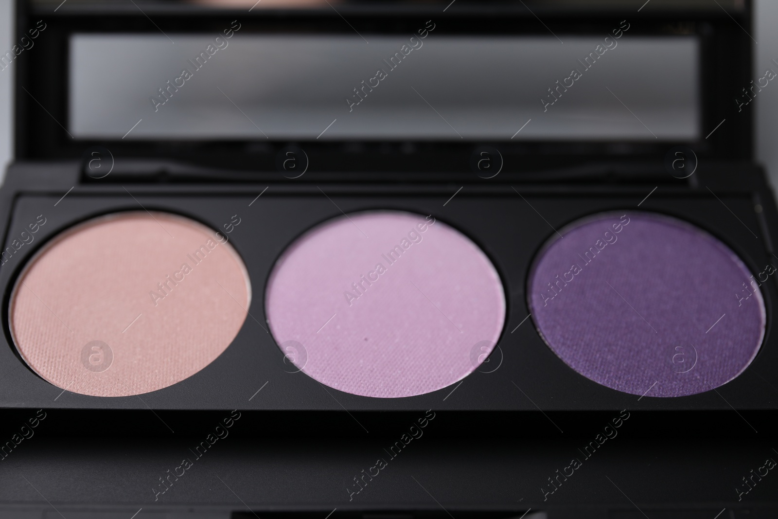 Photo of Beautiful eyeshadow palette as background, closeup. Professional cosmetic product