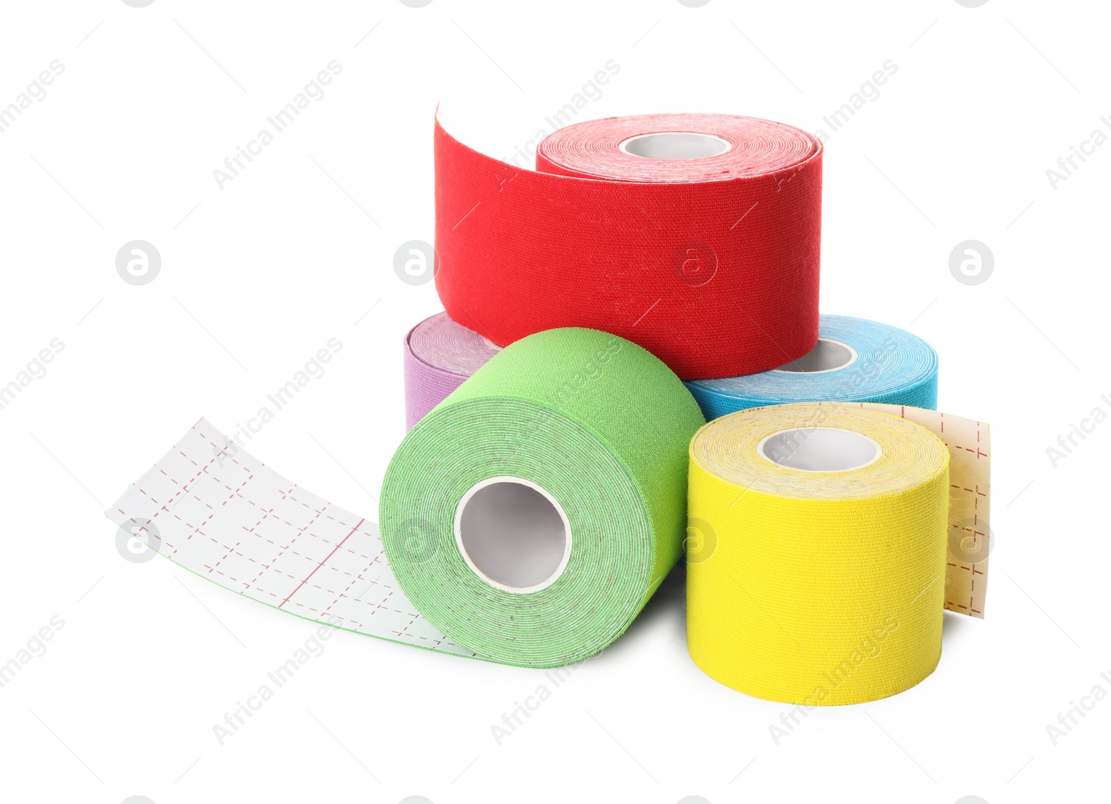 Photo of Many bright kinesio tape in rolls on white background