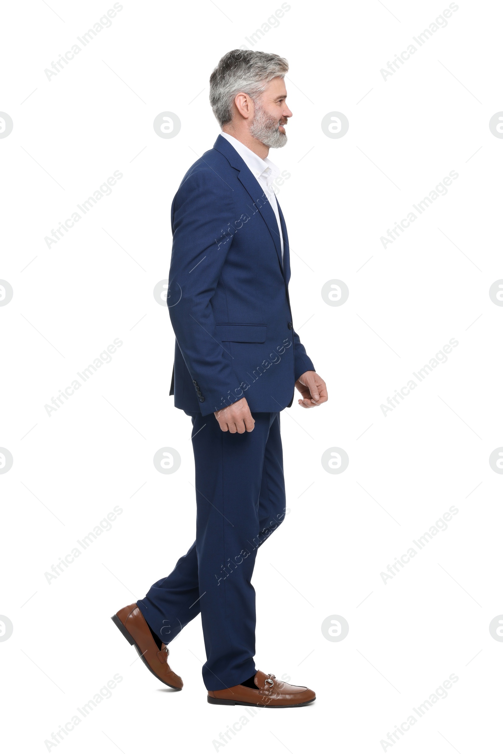 Photo of Mature businessman in stylish clothes posing on white background