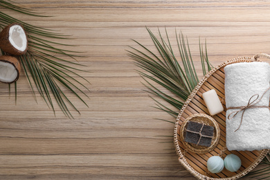 Photo of Flat lay composition with handmade soap on wooden background. Space for text